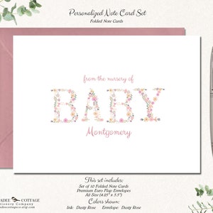 May include: Set of 10 folded note cards with floral letter design that spells "BABY" with the name "Montgomery" below. The cards are dusty rose and come with dusty rose envelopes. The cards are 4.25 inches by 5.5 inches.