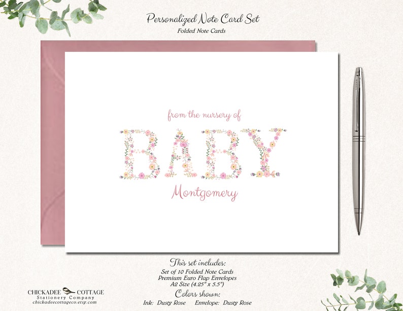 May include: Set of 10 folded note cards with floral letter design that spells "BABY" with the name "Montgomery" below. The cards are dusty rose and come with dusty rose envelopes. The cards are 4.25 inches by 5.5 inches.