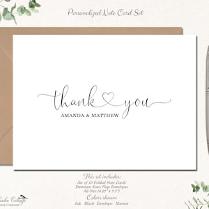 May include: A personalized note card set with a white card featuring the words "thank you" in elegant script, with the names "AMANDA & MATTHEW" below. The set includes a brown envelope and a silver pen. The text "Personalized Note Card Set" is at the top.