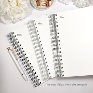 May include: Three notebooks with different colored binding coils: black, white, and silver. The text "Your choice of black, white or silver binding coils" is below the notebooks.