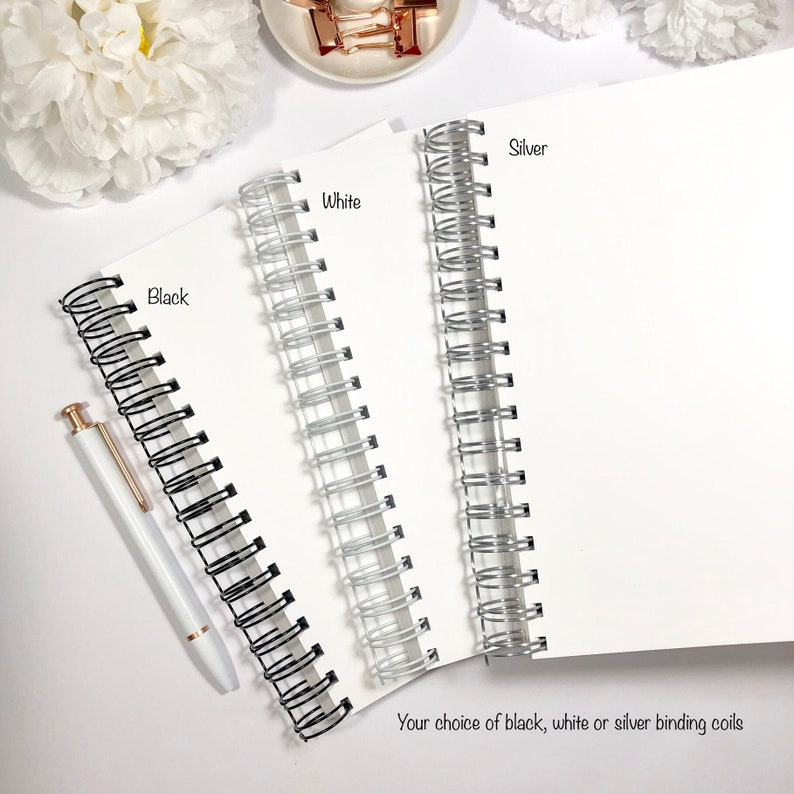 May include: Three notebooks with different colored binding coils: black, white, and silver. The text "Your choice of black, white or silver binding coils" is below the notebooks.