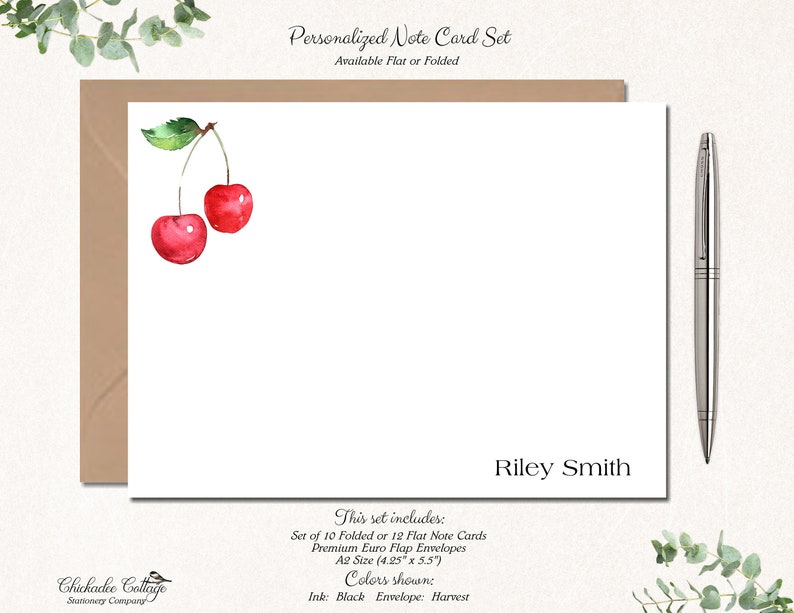 May include: Personalized note card set with a watercolor illustration of two red cherries. The set includes 10 folded or 12 flat note cards and premium Euro flap envelopes in A2 size (4.25 inches by 5.5 inches). The ink color is black and the envelope color is harvest.