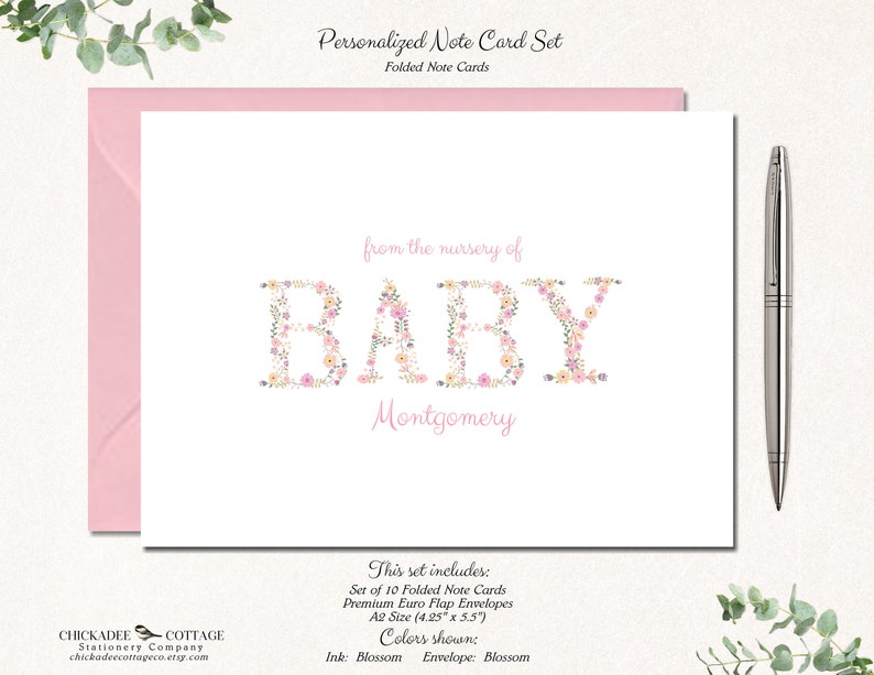 May include: A set of 10 folded note cards with floral lettering that spells out "BABY" and the name "Montgomery". The cards are pink and white with a floral design. The set includes premium Euro flap envelopes in A2 size (4.25" x 5.5").
