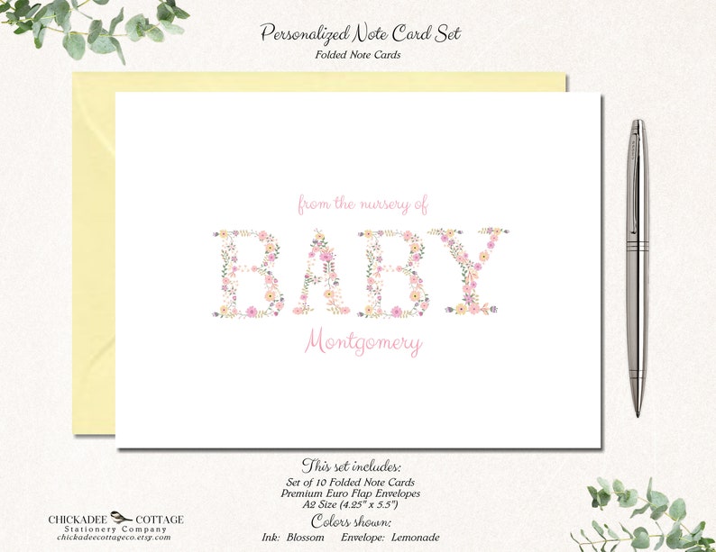 May include: Set of 10 folded note cards with pink and white floral letters spelling "BABY" with the name "Montgomery" below. The cards are 4.25 inches by 5.5 inches and come with envelopes. The ink color is blossom and the envelope color is lemonade.