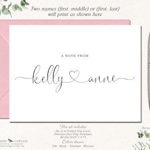 May include: A white folded note card with the names "kelly & anne" in a cursive font, with a heart symbol between the names. The card is inside a pink envelope. The text "A NOTE FROM" is above the names. The set includes 10 folded note cards and premium envelopes.