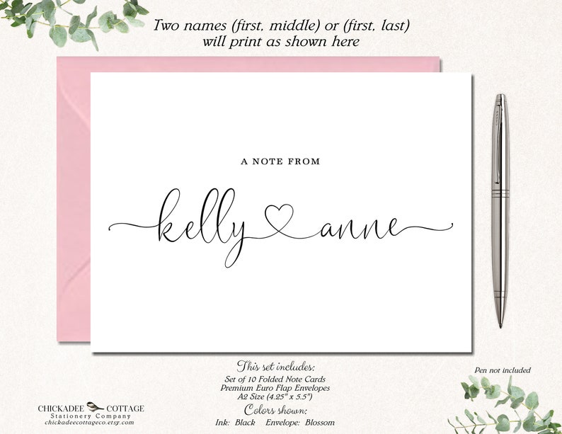 May include: A white folded note card with the names "kelly & anne" in a cursive font, with a heart symbol between the names. The card is inside a pink envelope. The text "A NOTE FROM" is above the names. The set includes 10 folded note cards and premium envelopes.