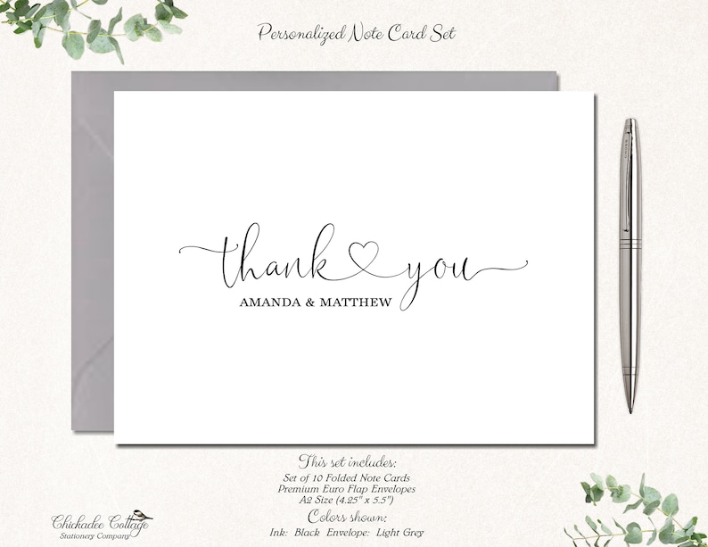 May include: A white note card with the words "thank you" in elegant script, with the names "AMANDA & MATTHEW" below. The card is accompanied by a gray envelope and a silver pen. The set includes 10 folded cards, A2 size (4.25" x 5.5").