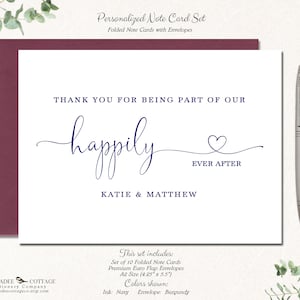May include: A personalized note card set with a burgundy envelope and navy ink. The card reads "Thank you for being part of our happily ever after" with the names Katie & Matthew. A silver pen rests beside the card.