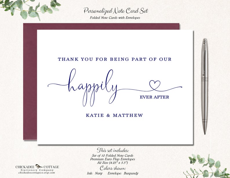 May include: A personalized note card set with a burgundy envelope and navy ink. The card reads "Thank you for being part of our happily ever after" with the names Katie & Matthew. A silver pen rests beside the card.