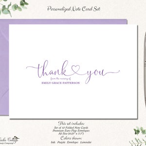 May include: A personalized note card set with a lavender envelope. The card features the words "thank you" in purple script, with the name "EMILY GRACE PATTERSON" below. A silver pen rests on the right side of the card.