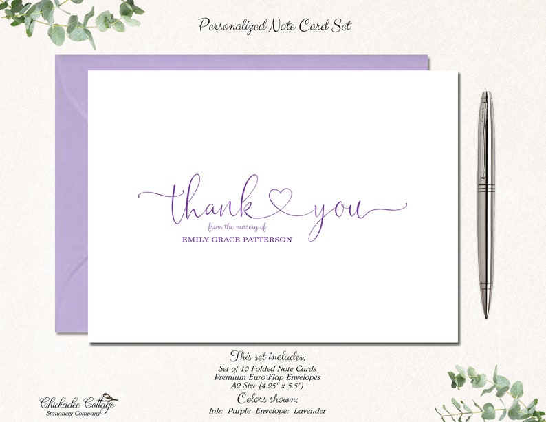 May include: A personalized note card set with a lavender envelope. The card features the words "thank you" in purple script, with the name "EMILY GRACE PATTERSON" below. A silver pen rests on the right side of the card.