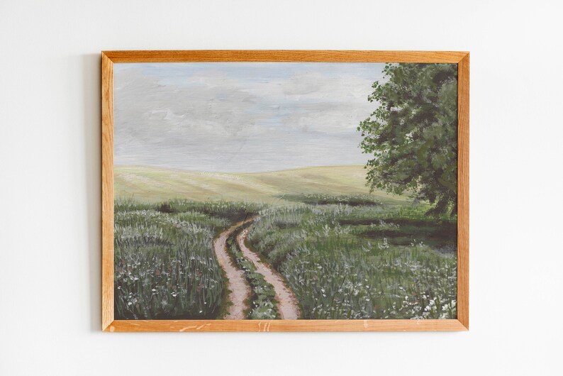 May include: A painting of a winding dirt road leading through a field of green grass and white wildflowers. A single tree stands on the right side of the road, with a cloudy sky in the background.