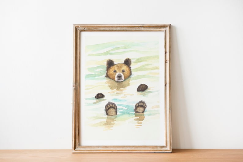 May include: A watercolor painting of a brown bear swimming in a blue and green lake. The bear is looking directly at the viewer with its head and paws above the water.