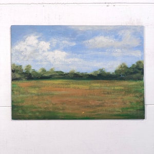 May include: A painting depicting a field with green grass and a brown dirt path. The sky is blue with white clouds.