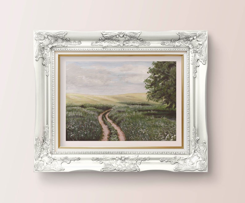 May include: A framed painting of a landscape with a dirt road leading through a field of green grass and white flowers. The sky is a light blue with white clouds. A single tree stands on the right side of the road.