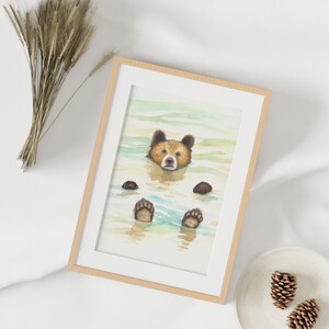 May include: A watercolor painting of a brown bear swimming in a blue and green body of water. The bear's head is above the water and its paws are visible below the surface.