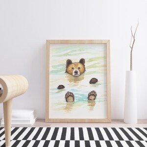 May include: A watercolor painting of a brown bear with its head and paws sticking out of the water. The bear is looking directly at the viewer. The water is a light blue and green color.