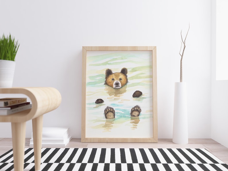 May include: A watercolor painting of a brown bear with its head and paws sticking out of the water. The bear is looking directly at the viewer. The water is a light blue and green color.