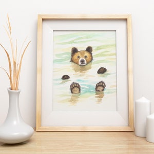 May include: Watercolor painting of a brown bear floating in a body of water. The bear's head is above the water and its paws are submerged. The water is a light blue color and the background is a light green.