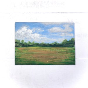 May include: A painting depicting a field with a line of trees in the background. The sky is blue with white clouds. The field is green and brown.