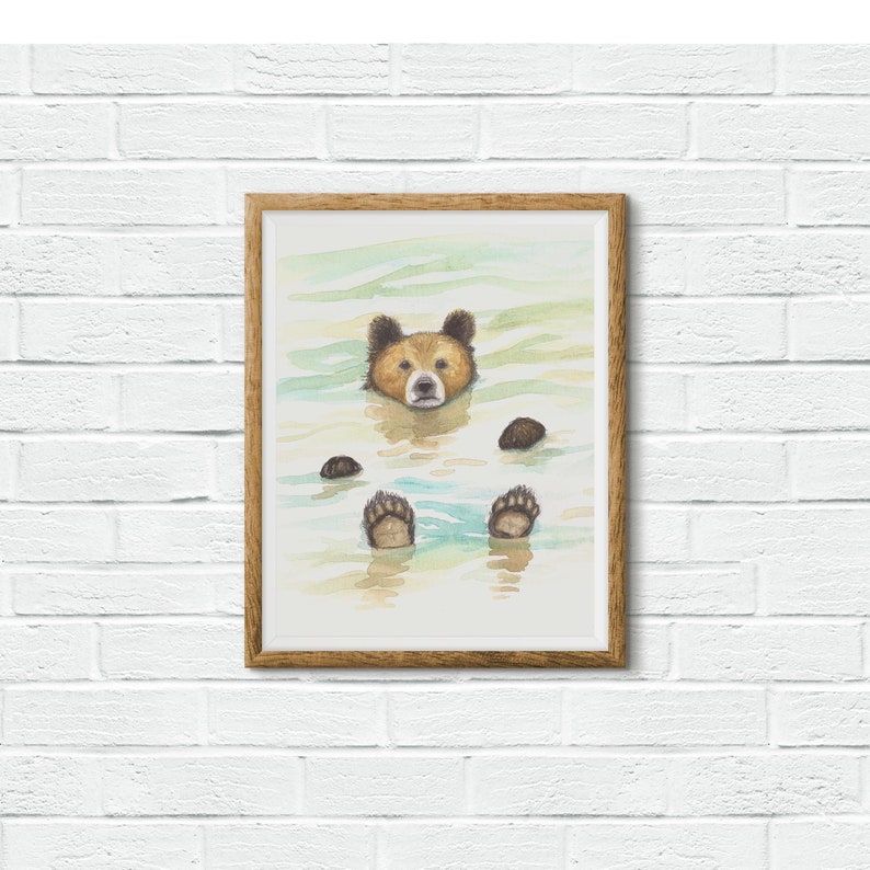 May include: A watercolor painting of a brown bear floating in water with its head and paws visible. The bear has a light brown nose and dark brown eyes. The water is a light blue and green color.