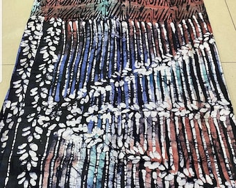 May include: Black fabric with a white and blue batik pattern. The pattern features vertical lines and a leaf design. The fabric has a textured look.