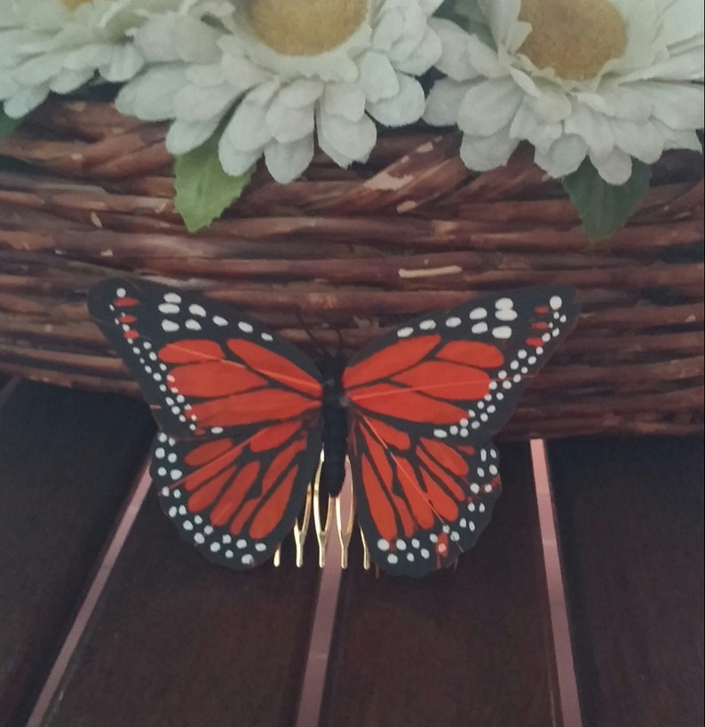 Orange feather comb with butterfly