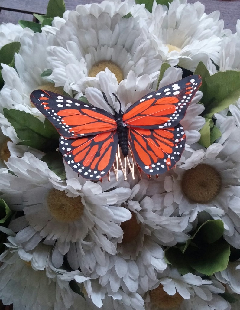 Orange feather comb with butterfly