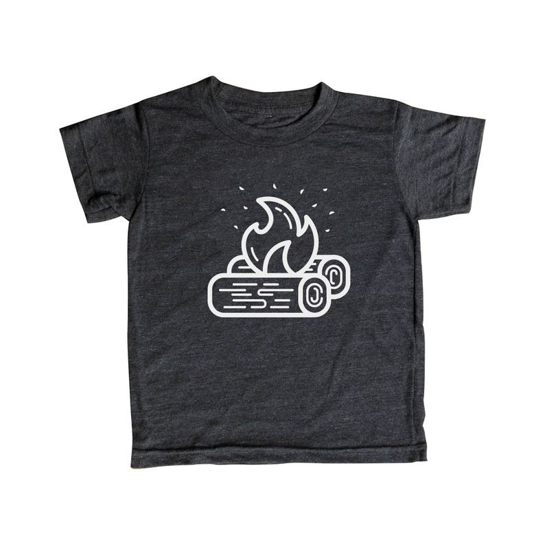 May include: A dark gray t-shirt with a white outline of a campfire with flames and logs.