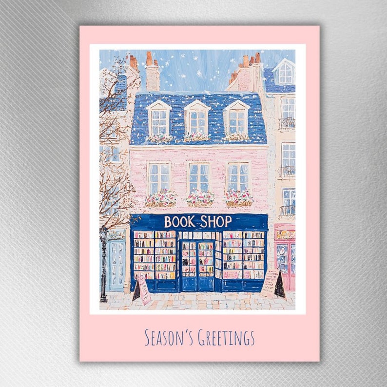 Pink Holiday Card Set made by TinyCottageKitchen, a pink-bordered card with the image of a pink bricked book shop with blue window borders. The building is in between two other bricked buildings.