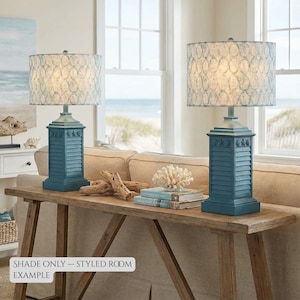 May include: Two matching teal table lamps with patterned shades sit on a wooden console table. The lamps have a column-style base with a shutter design. The text "SHADE ONLY - STYLED ROOM EXAMPLE" is visible.