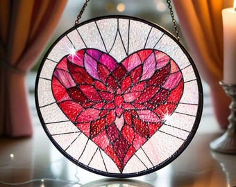May include: A stained glass heart-shaped window hanging with a chain. The heart is made of red, pink, and purple glass pieces. The background is white with a subtle iridescent shimmer.