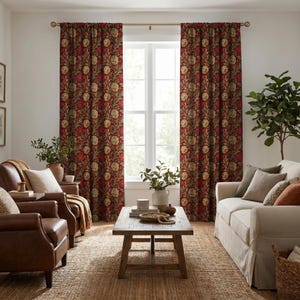 May include: Living room with red floral patterned curtains, a light-colored sofa, and two brown leather armchairs. A wooden coffee table sits on a woven rug. A large potted plant is in the corner.