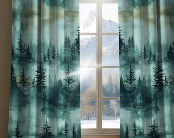 May include: A pair of floor-length curtains featuring a watercolor-style print of a dense forest with dark green pine trees against a lighter teal and white background, hanging on either side of a window that reveals a snowy mountain landscape.