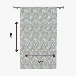 May include: A rectangular curtain featuring a repeating pattern of light-colored leaves and thin branches on a dusty blue background. The curtain is suspended from a rod and measures 84 inches in height by 50 inches in width as indicated.