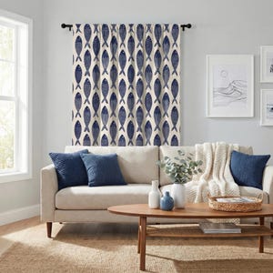 May include: A window curtain featuring a repeating pattern of dark blue fish on a cream-colored background. The curtain is hung on a black rod and displays a vertical orientation with multiple rows of fish arranged in a consistent, repeating layout.