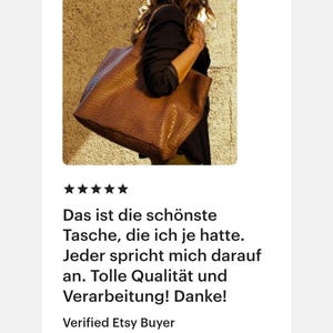 May include: A large, brown, rectangular tote bag with a textured, embossed surface pattern. The bag features two sturdy shoulder straps and is carried at the side, showcasing its structured shape and deep, warm brown color against a textured wall.
