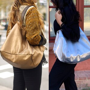 May include: Two women are shown wearing different sizes of a gold and silver tote bag. The woman on the left is wearing a gold tote bag and the woman on the right is wearing a silver tote bag. The text "LARGE SIZE" and "MEDIUM SIZE" is shown below the women.