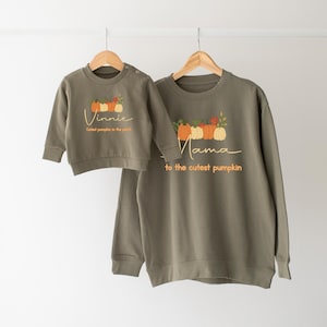 May include: Two green sweatshirts with pumpkin graphics. The smaller sweatshirt says "Vinnie Cutest pumpkin in the patch". The larger sweatshirt says "Mama to the cutest pumpkin".