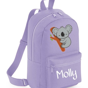 May include: Purple backpack with a koala bear graphic and the name "Molly" embroidered on the front pocket.