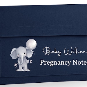 May include: A navy blue folder for pregnancy notes with a flap closure. It features a watercolour illustration of a grey elephant holding a white balloon. Text reads "Baby Williams Pregnancy Notes."