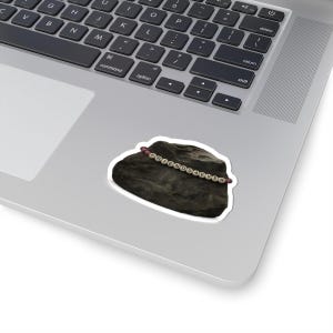 May include: A sticker depicting a dark grey rock with a beaded bracelet spelling "FRIENDSAEVER". The sticker is placed on a laptop.