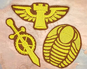 May include: Four yellow embroidered patches on a brown background. The patches depict a tower with wings, a sword with a gear, a segmented shell, and a sword with a gear.
