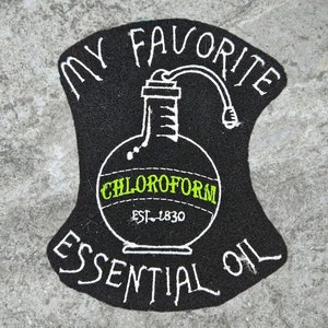 May include: Black and white illustration of a bottle labeled "Chloroform Essential Oil" with the text "My Favorite Est. 1830".