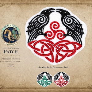 May include: Embroidered patch featuring two black ravens facing each other above a red Celtic knot design. The patch is white with black and red details. Text on the patch reads "Myth & Stitch Embroidery" and "Iron On/Sew On Patch". Available in green or red.
