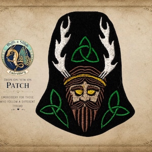 May include: A black iron-on or sew-on patch featuring an embroidered design of a bearded figure with white antlers, yellow eyes, and a gold headband. The patch includes three green triquetra symbols and is displayed with the text Myth a Stitch Embroidery.