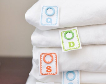 Simple to attach snap on labels that tell you the size of sheets and other bed linens for easy bed making.