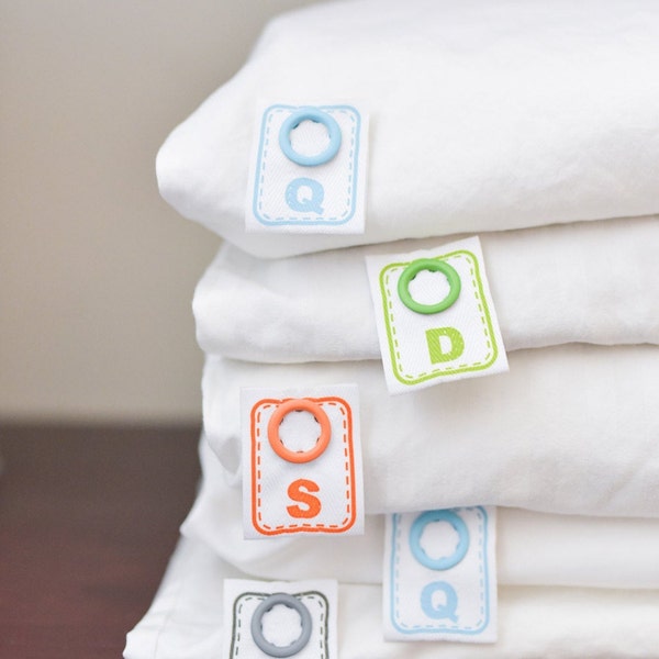 Simple to attach snap on labels that tell you the size of sheets and other bed linens for easy bed making.