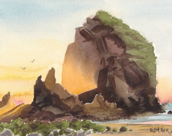 May include: Watercolor painting of a rocky cliff face with green foliage at the top, illuminated by a golden sunset. The cliff is situated on a beach with a body of water in the background.