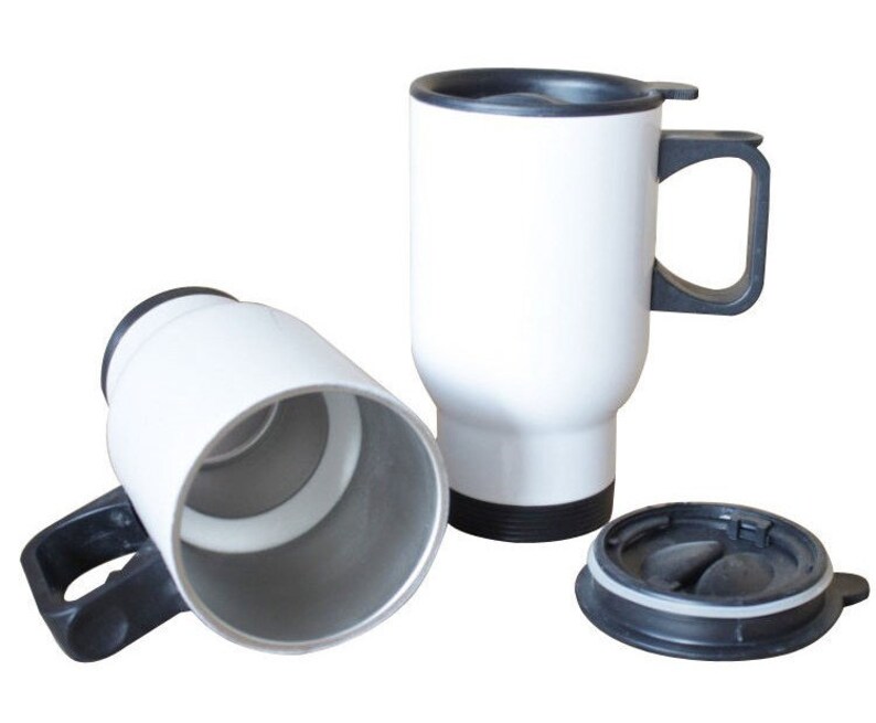 May include: White travel mugs with black handles and lids. One mug is upright, another is on its side, and the lid is separate. The mugs are designed to keep beverages hot or cold. The mugs are approximately 6 inches tall.